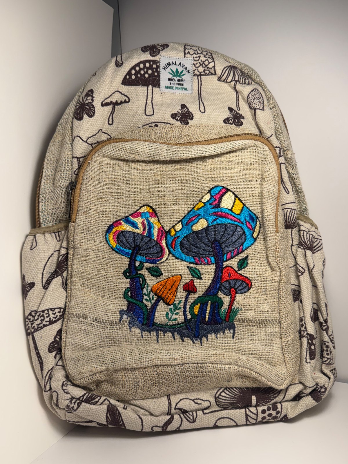 Cream canvas backpack hand block printed with mushrooms, view 1