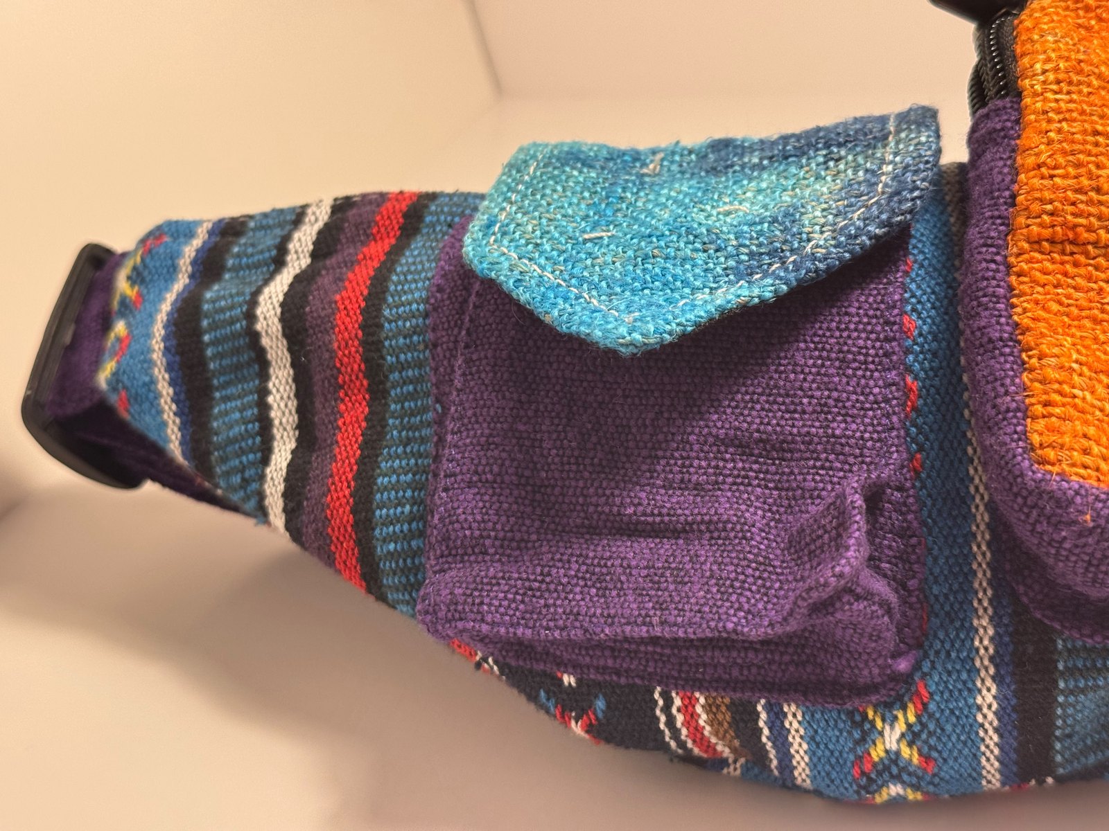 Mauve striped hemp messenger bag with woven teal trim