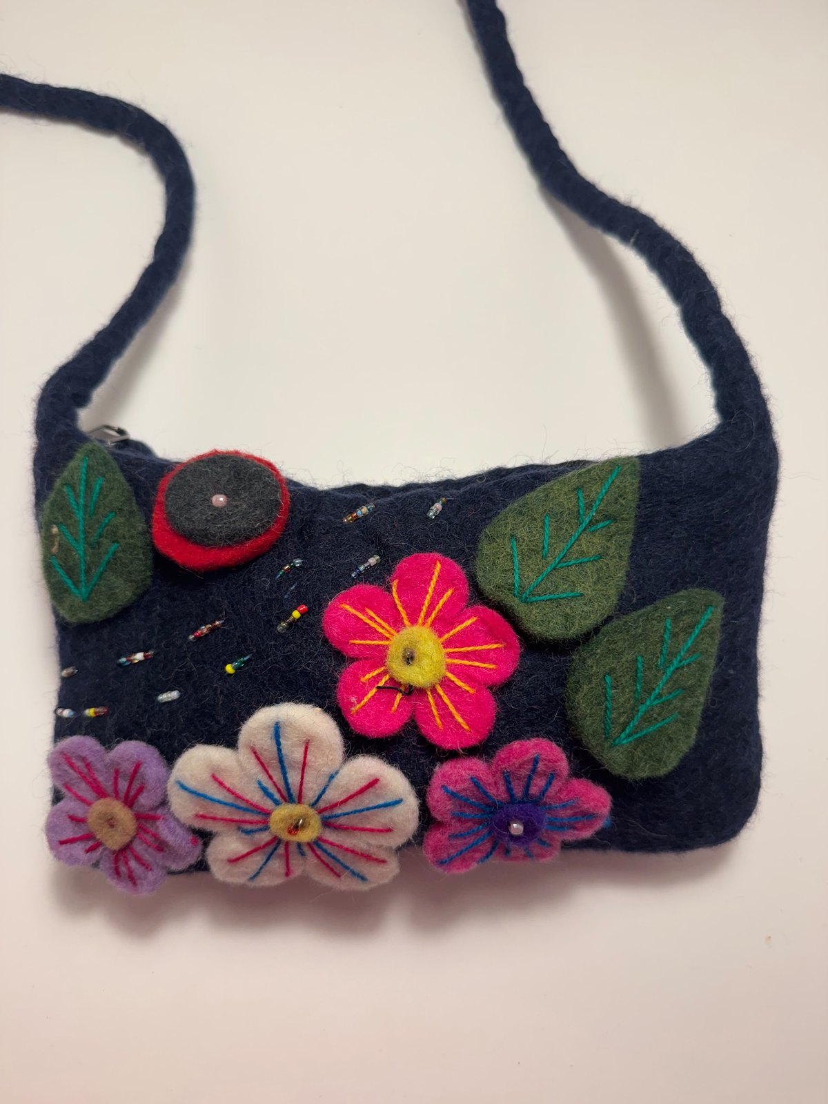 Navy wool felt shoulder bag with hand stitched felt flowers, view 1