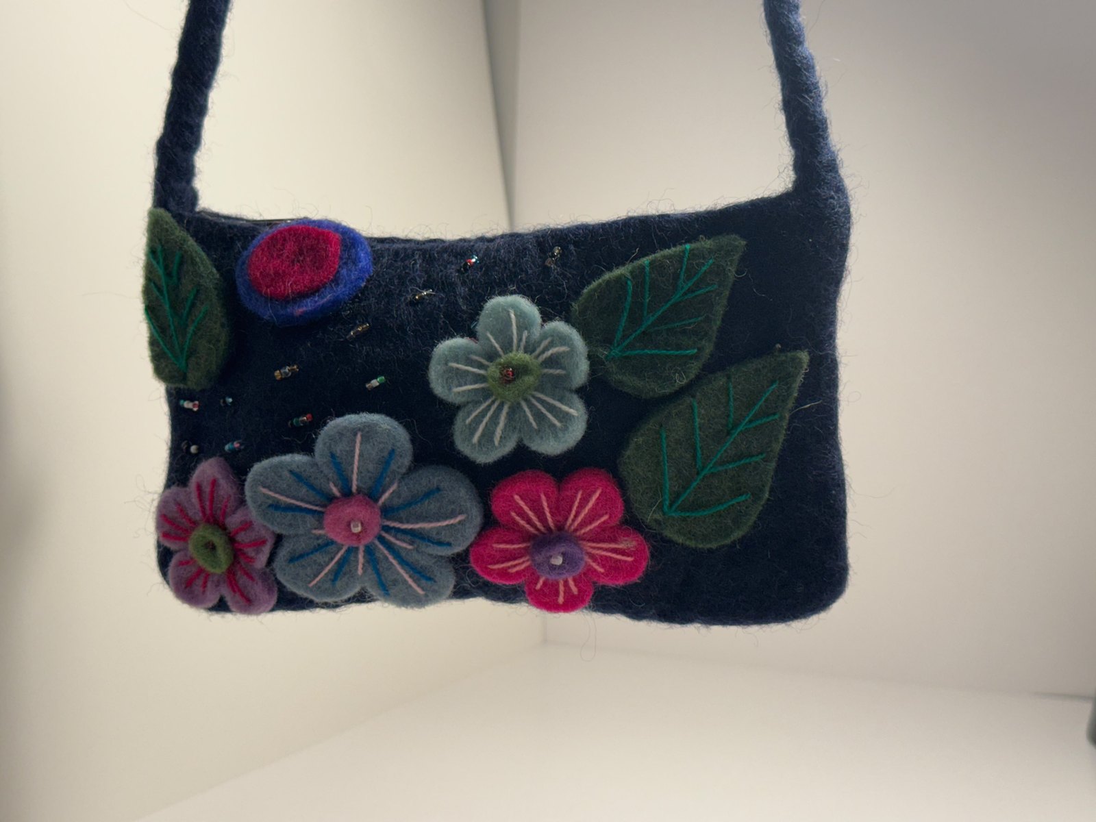 Navy wool felt shoulder bag with hand stitched felt flowers, view 3