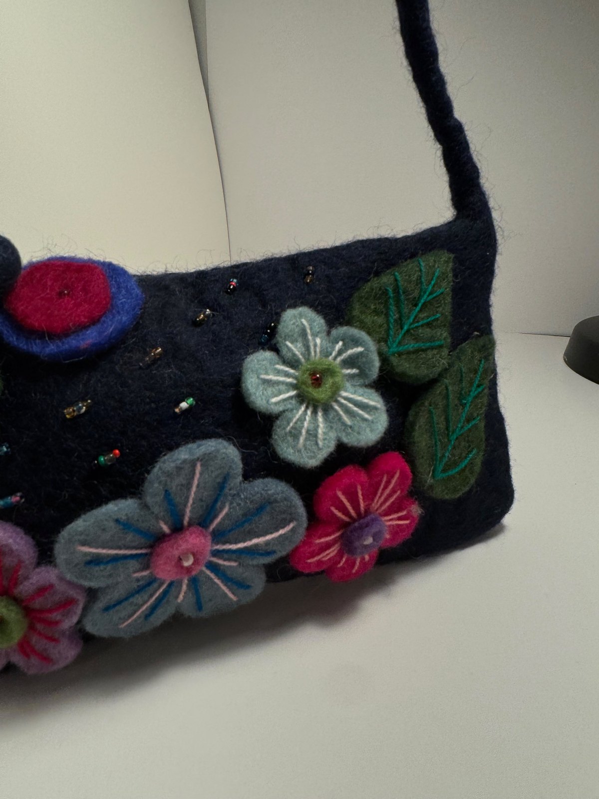 Navy wool felt shoulder bag with hand stitched felt flowers, view 6