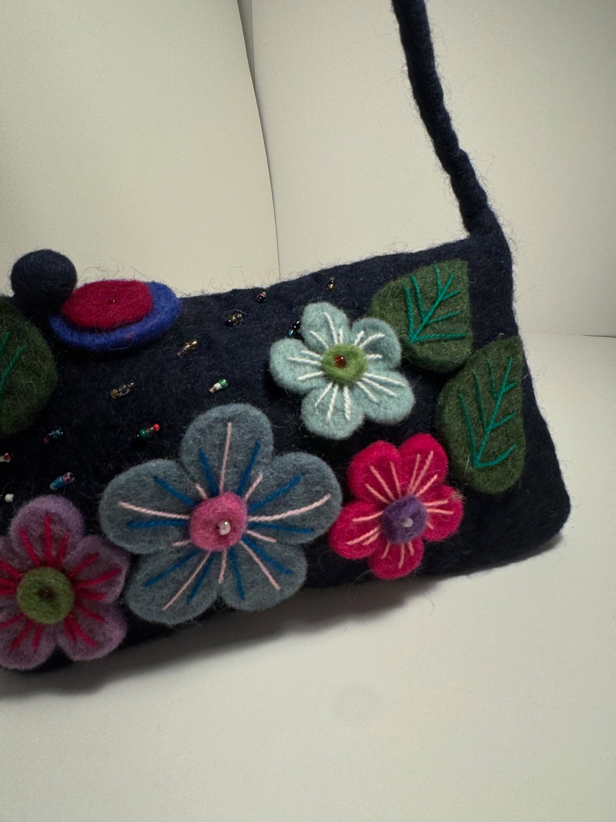 Navy wool felt shoulder bag with hand stitched felt flowers, view 10
