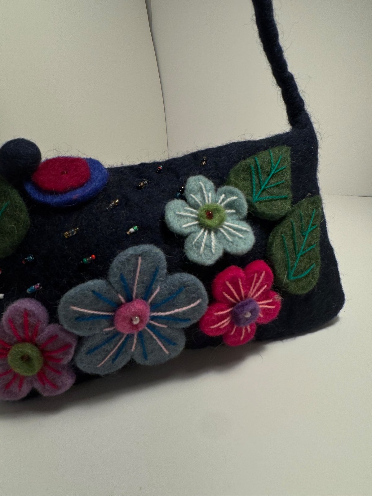 Navy wool felt shoulder bag with hand stitched felt flowers, view 13