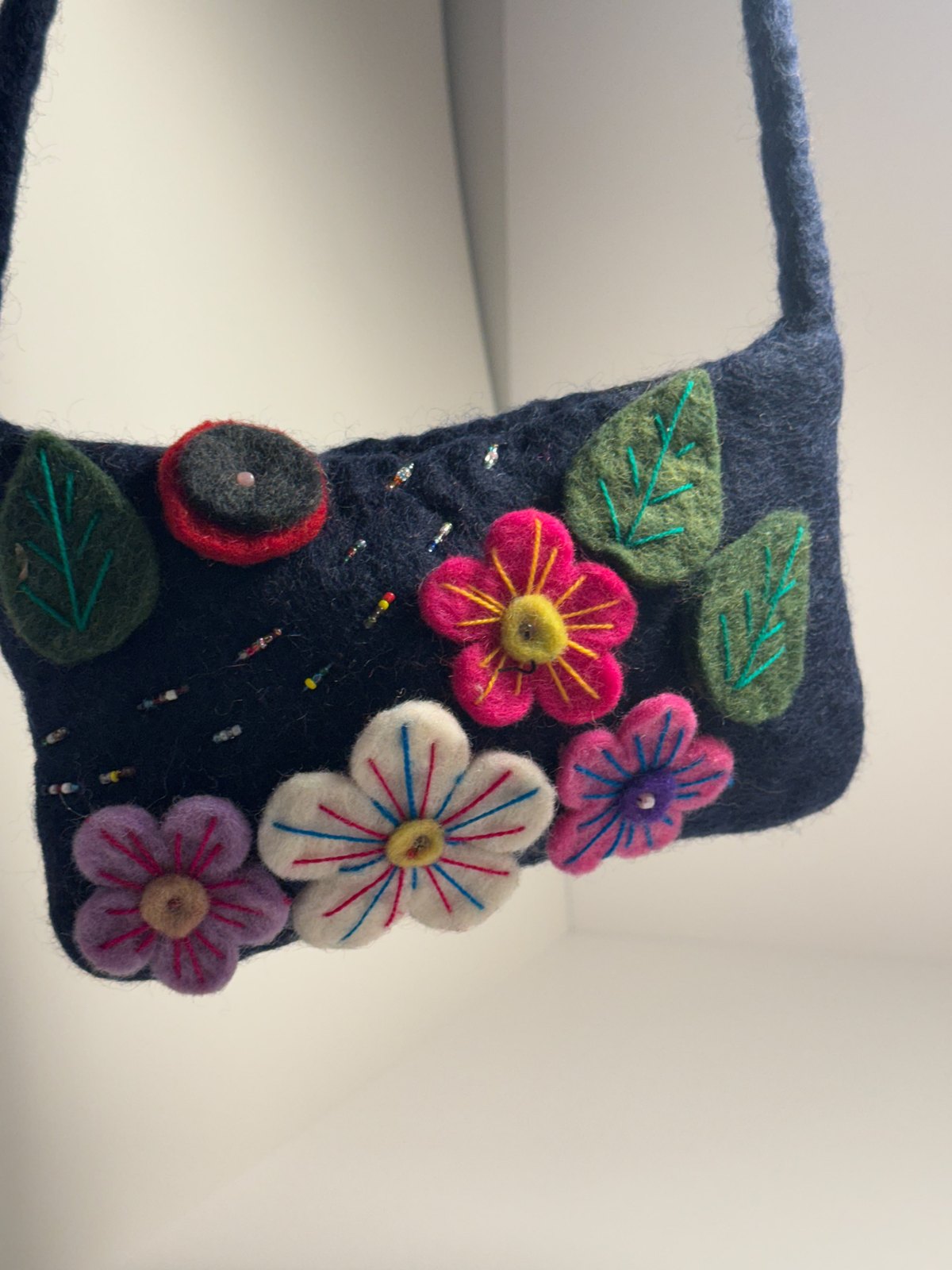 Navy wool felt shoulder bag with hand stitched felt flowers, view 16