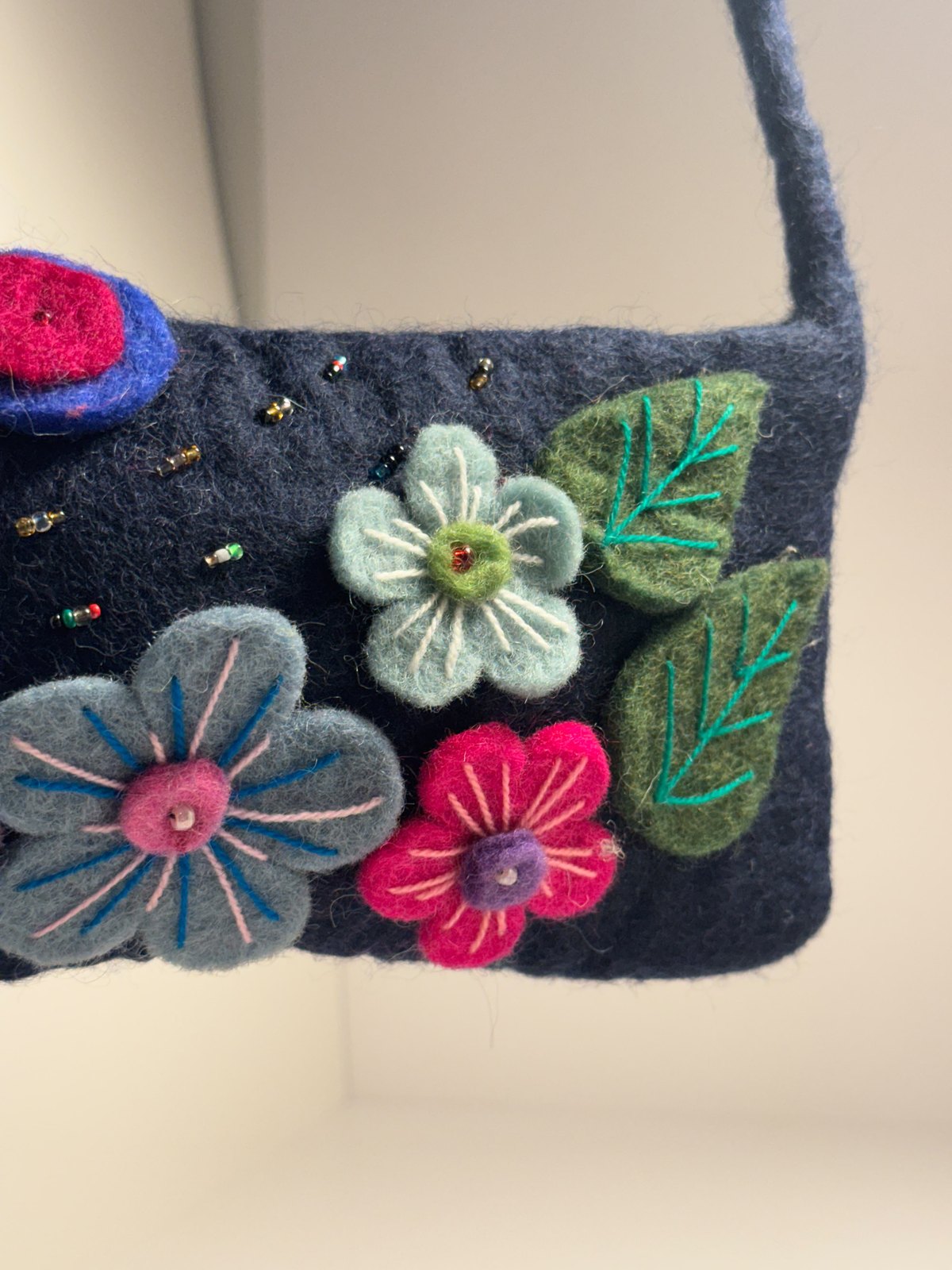 Navy wool felt shoulder bag with hand stitched felt flowers, view 17